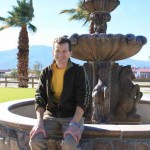 Portrait of Tom Struzzieri sitting on a fountain at the HITS Desert Horse Park.