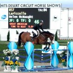 Caruschka's tail flies like a flag in the wind as she carries Eduardo Menezes over a jump.